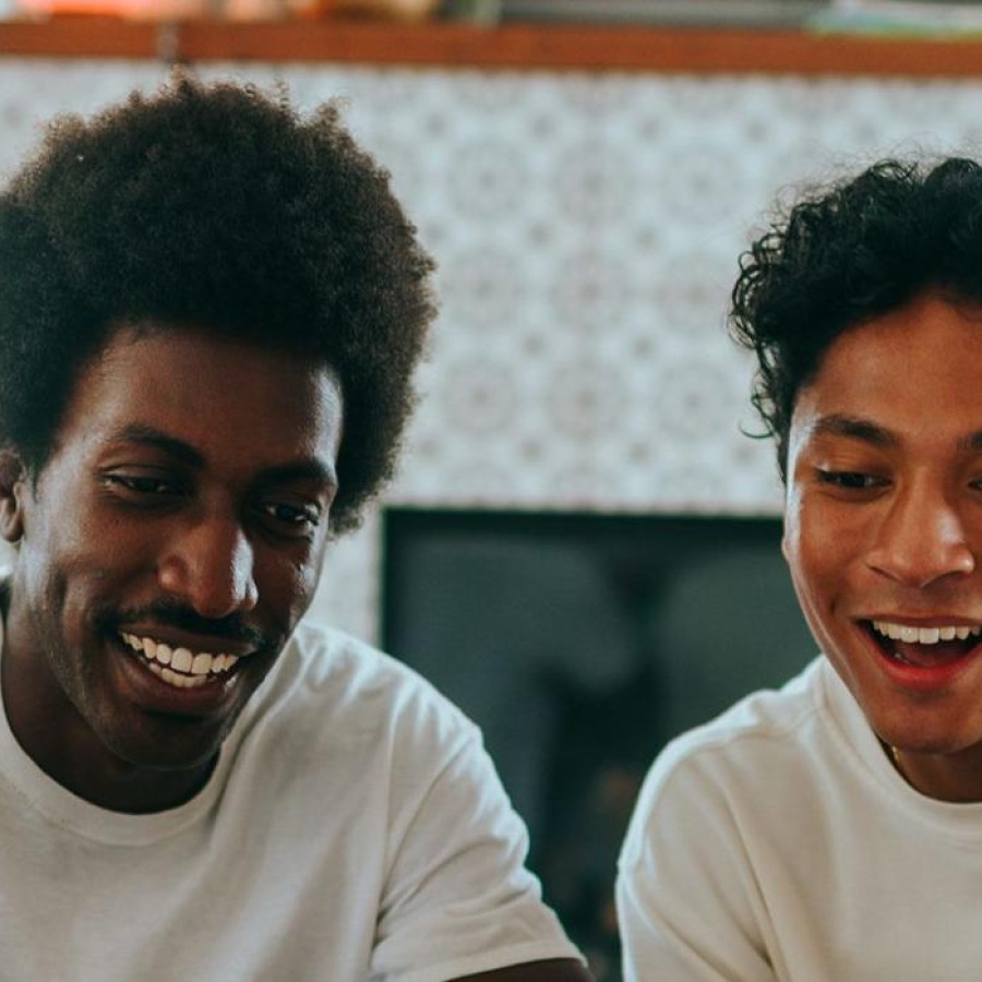 father and son sit together in living room